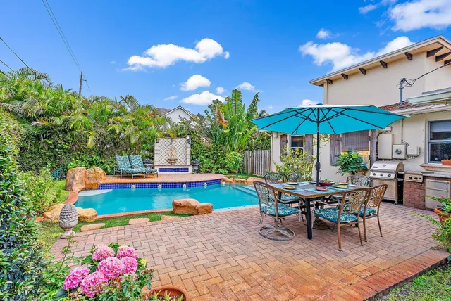 a view of a swimming pool with chairs in patio