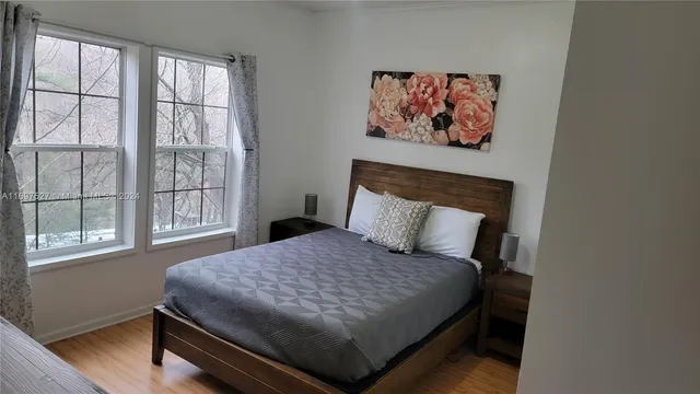 a bed sitting in a bedroom next to a window