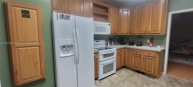 a kitchen with cabinets appliances and a sink