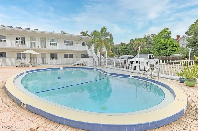 a balcony with chairs and wooden floor
