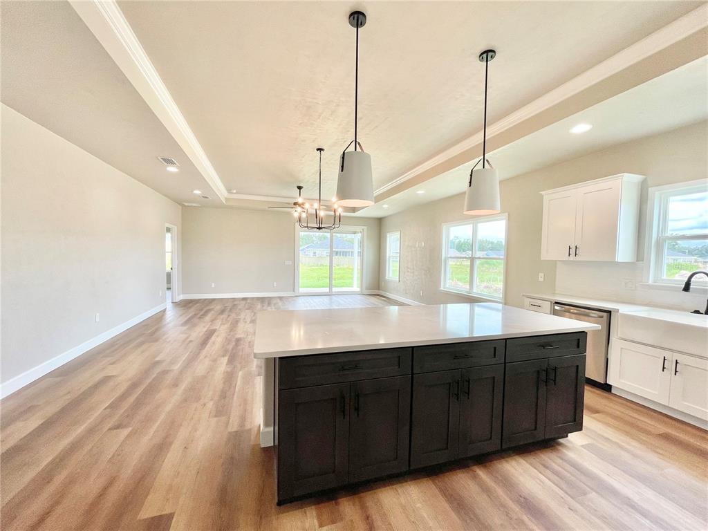 1021 Southwest 67th Street Gainesville, FL 32607 - Photo 5 of 53 a kitchen with kitchen island sink and wooden floor