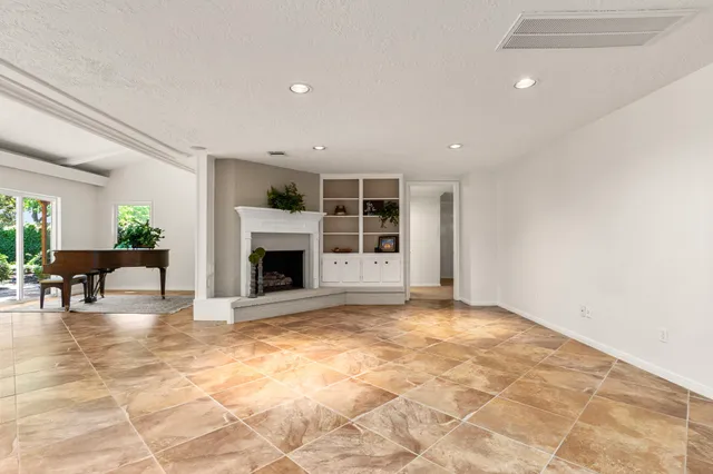 a view of a livingroom with a fireplace and window