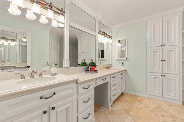 a spacious bathroom with a double vanity sink mirror and