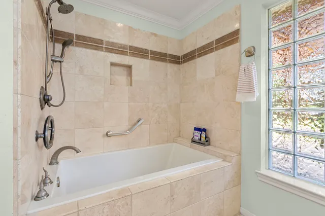 a bathroom with a bath tub with a shower