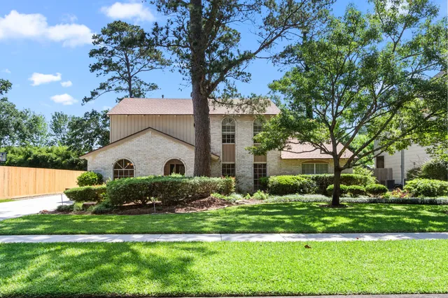 a front view of house with yard and green space