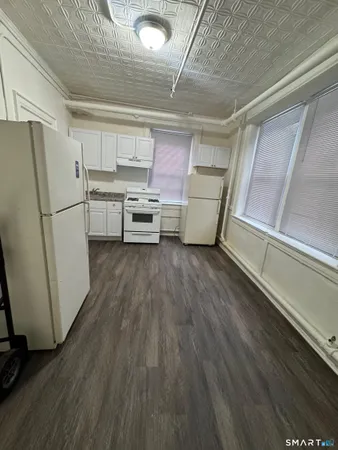 a kitchen with stainless steel appliances a refrigerator and a stove top oven