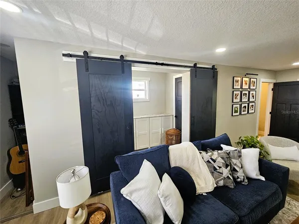 a living room with furniture window and wooden floor