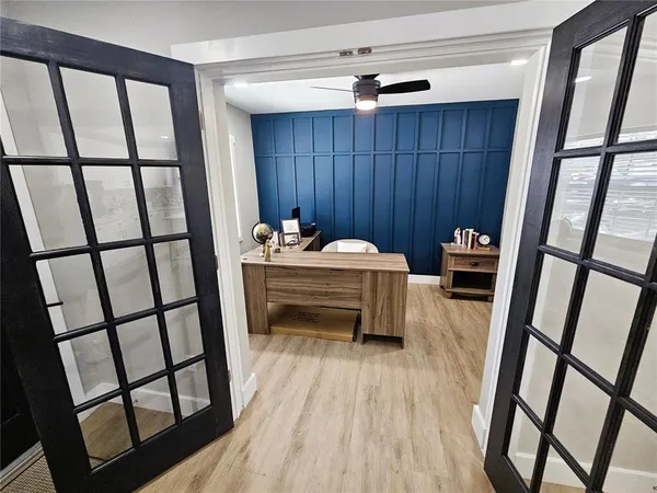 a reading room with furniture and hardwood floor