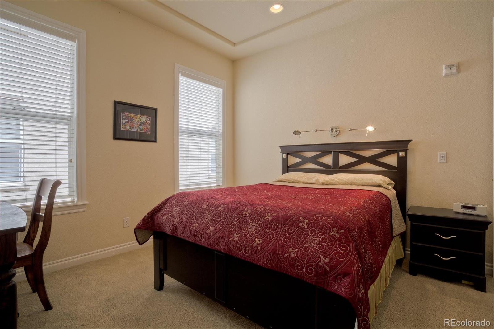 40 Madison Street, Unit 208 Denver, CO 80206 - Photo 11 of 20 a spacious bedroom with a bed and a desk