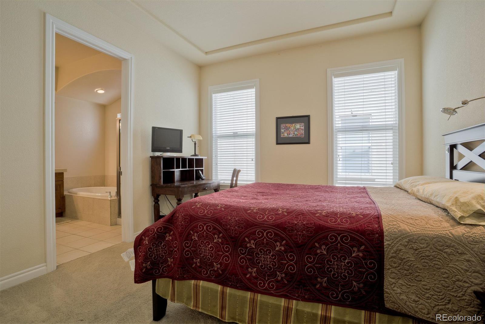 40 Madison Street, Unit 208 Denver, CO 80206 - Photo 12 of 20 a bedroom with a bed and a television