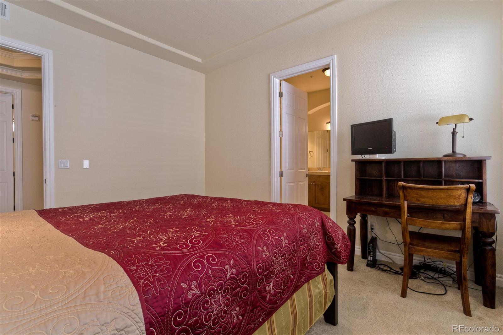 40 Madison Street, Unit 208 Denver, CO 80206 - Photo 13 of 20 a bedroom with a bed and a desk