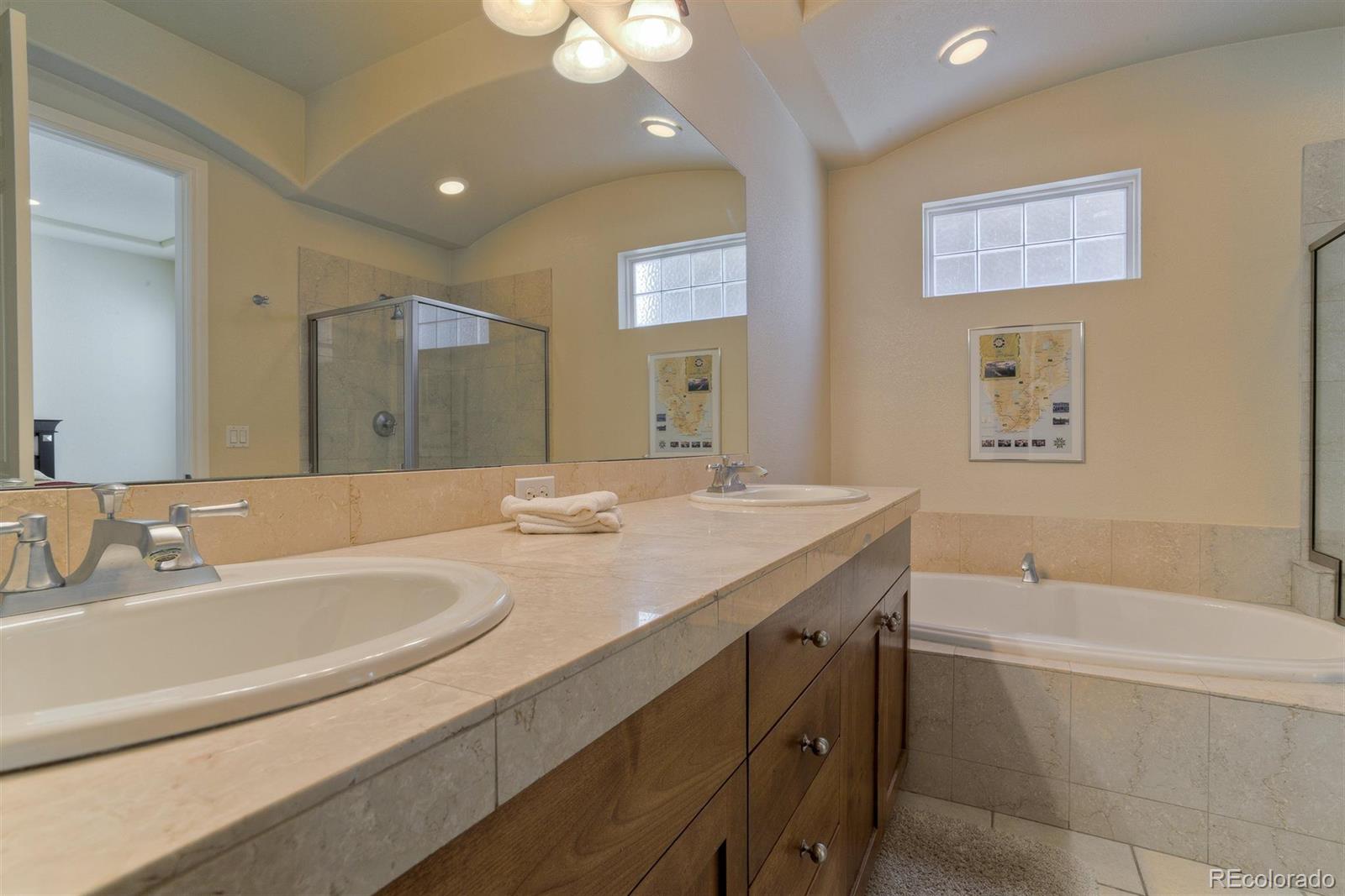 40 Madison Street, Unit 208 Denver, CO 80206 - Photo 15 of 20 a bathroom with a granite countertop sink a large mirror and a bathtub