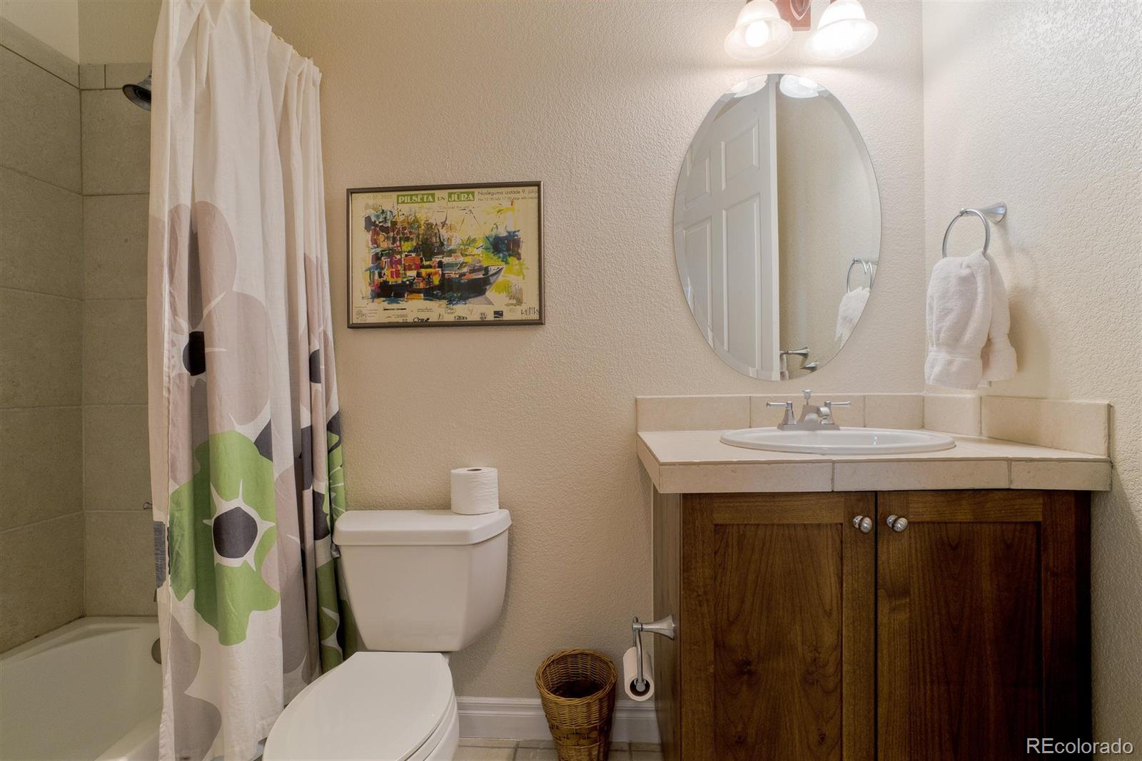 40 Madison Street, Unit 208 Denver, CO 80206 - Photo 18 of 20 a bathroom with a toilet a sink and a mirror