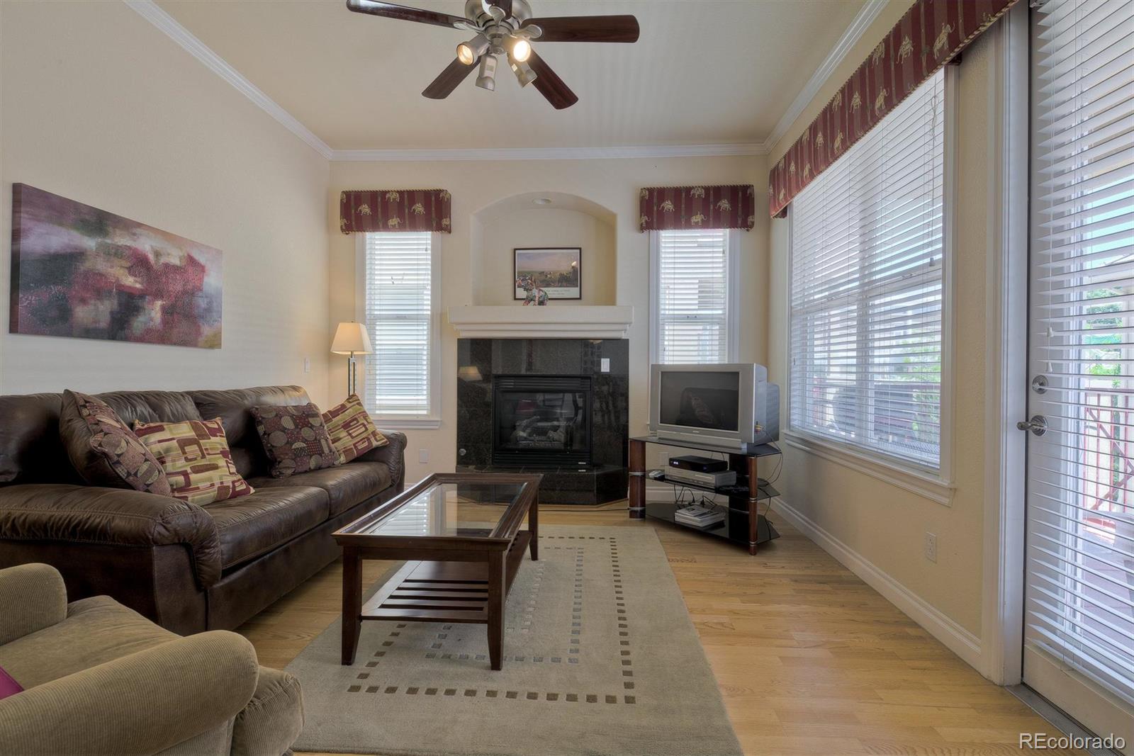 40 Madison Street, Unit 208 Denver, CO 80206 - Photo 4 of 20 a living room with furniture a flat screen tv and a fireplace