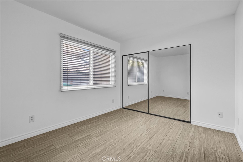 28661 Charreadas Laguna Niguel, CA 92677 - Photo 11 of 29 an empty room with wooden floor and windows