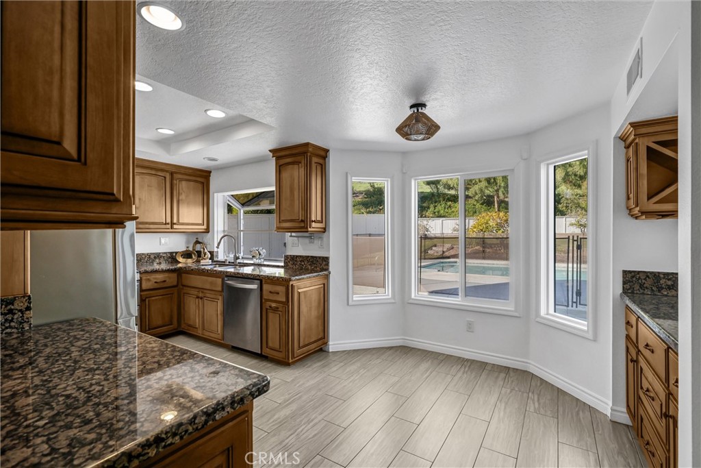 28661 Charreadas Laguna Niguel, CA 92677 - Photo 29 of 29 a kitchen with a stove a sink and a refrigerator
