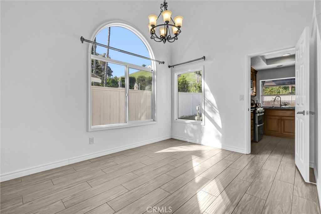 28661 Charreadas Laguna Niguel, CA 92677 - Photo 3 of 29 a view of an empty room with wooden floor and a window