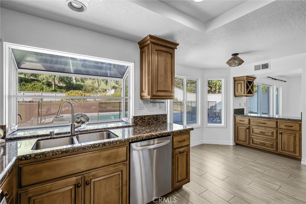 28661 Charreadas Laguna Niguel, CA 92677 - Photo 4 of 29 a kitchen with stainless steel appliances granite countertop a sink stove and refrigerator