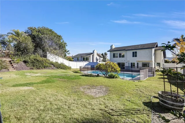 a view of a house with backyard porch and sitting area