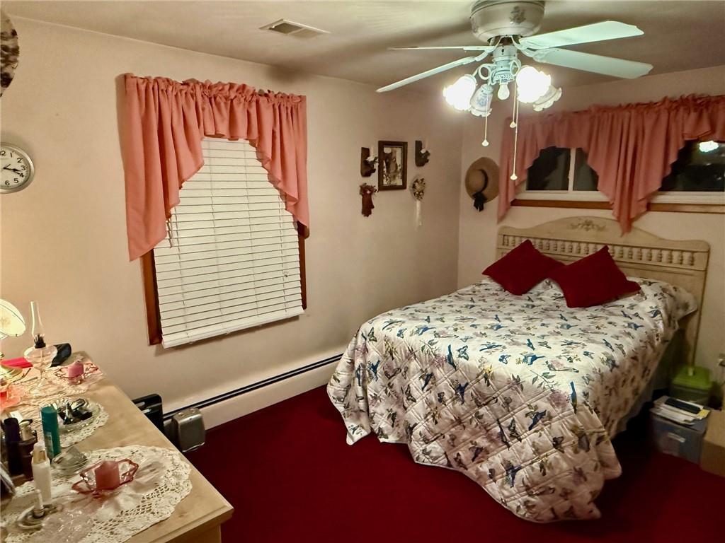 65 Glenn Road Mercer, PA 16137 - Photo 18 of 44 a bedroom with a bed and a chandelier