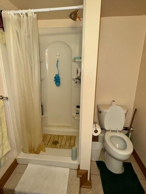 65 Glenn Road Mercer, PA 16137 - Photo 25 of 44 a white toilet sitting next to a bathroom sink and tub