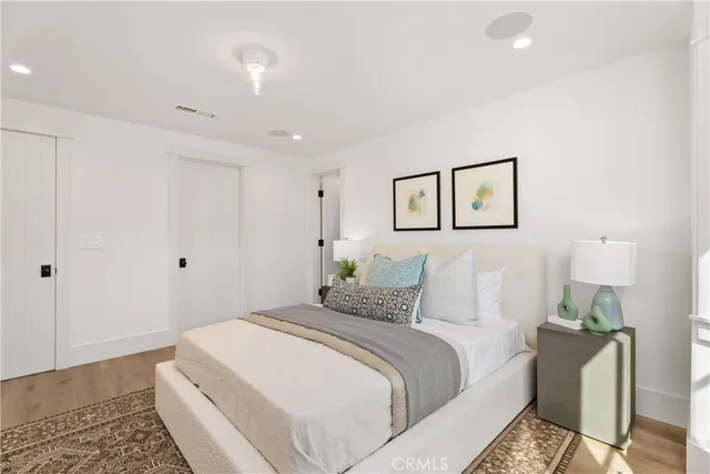 a bedroom with a bed and a painting on the wall