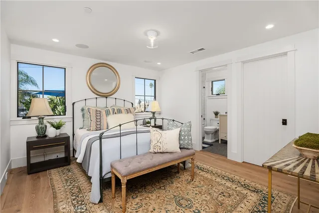 a bedroom with a bed and wooden floor