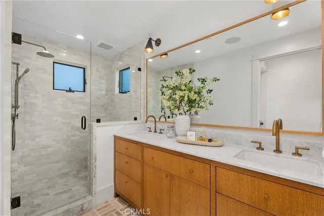 a bathroom with 2 sink double vanity and a mirror