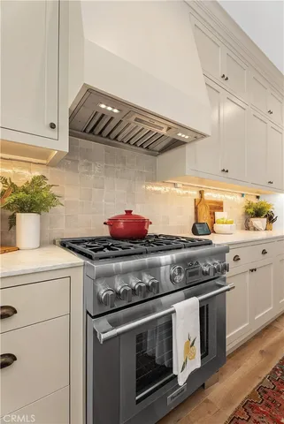 a stove top oven sitting inside of a kitchen