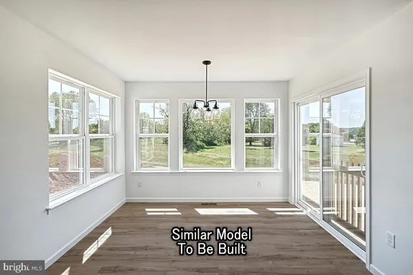 a view of a entryway door with wooden floor