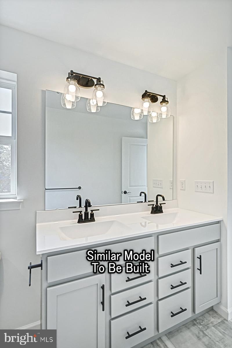 Meriwether Plan At The Seasons Dover, PA 17315 - Photo 20 of 30 a bathroom with a sink and a mirror