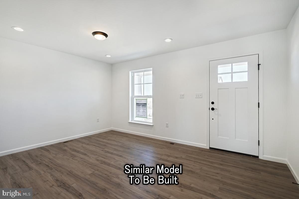Meriwether Plan At The Seasons Dover, PA 17315 - Photo 4 of 30 an empty room with wooden floor and window