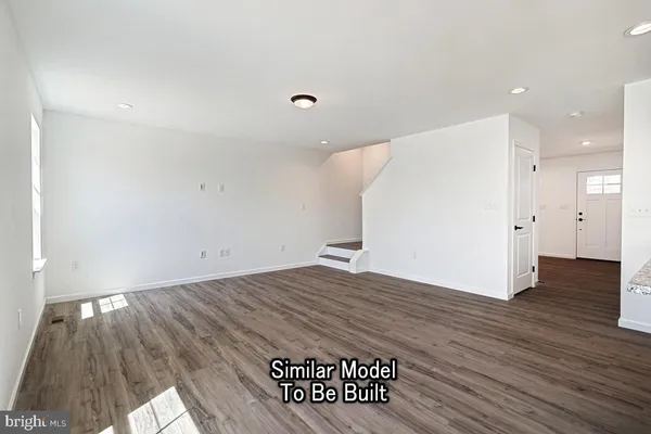 a view of a room with wooden floor and a sink
