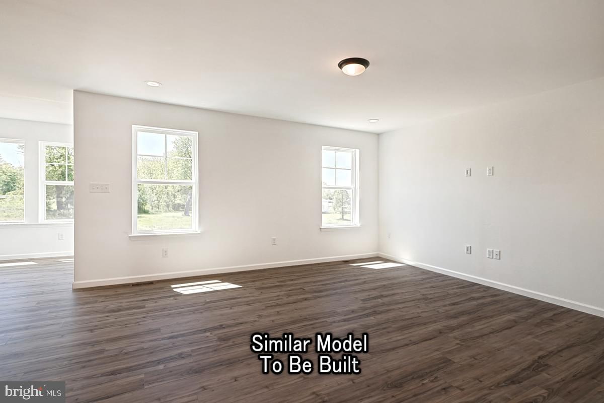 Meriwether Plan At The Seasons Dover, PA 17315 - Photo 7 of 30 an empty room with wooden floor and windows