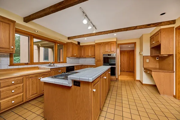 a kitchen with stainless steel appliances granite countertop a sink and cabinets