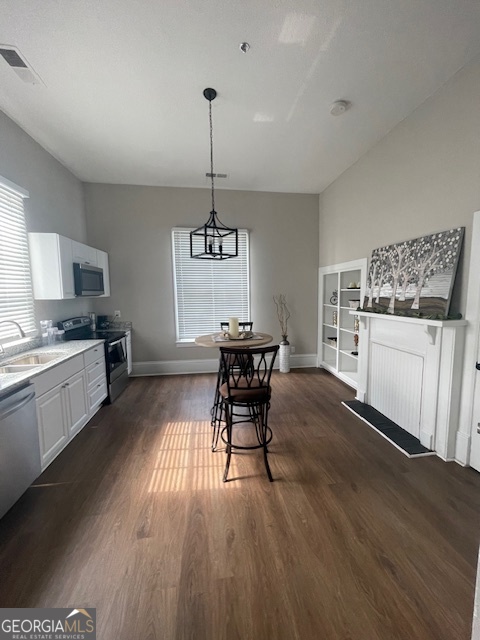 2001 Hamilton Road Columbus, GA 31904 - Photo 17 of 23 a kitchen with stainless steel appliances kitchen island hardwood floor sink stove and wooden cabinets