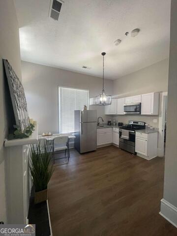 2001 Hamilton Road Columbus, GA 31904 - Photo 22 of 23 a kitchen with stainless steel appliances kitchen island granite countertop a table and chairs in it