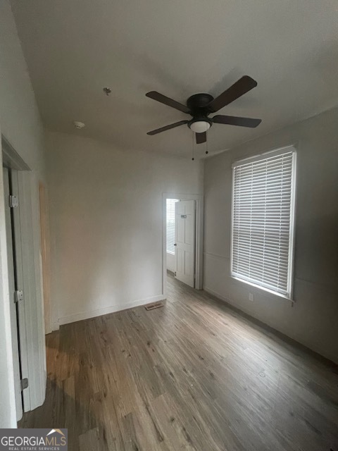 2001 Hamilton Road Columbus, GA 31904 - Photo 7 of 23 a view of an empty room with wooden floor and a window