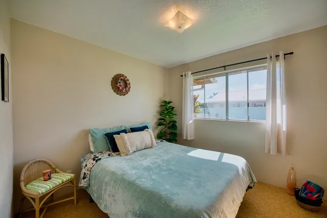 a bed sitting in a bedroom next to a window