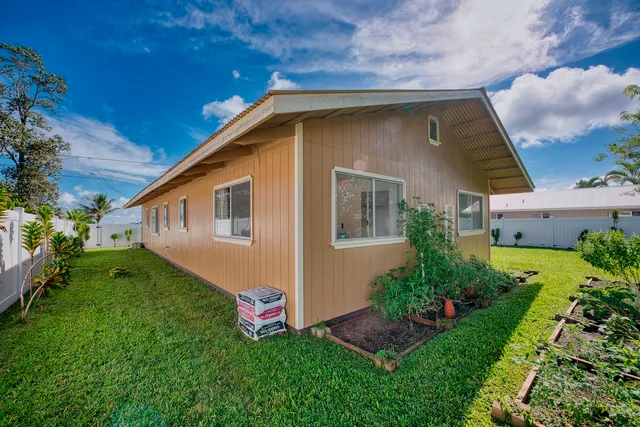 a front view of house with a garden