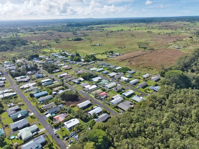 an aerial view of residential houses with outdoor space