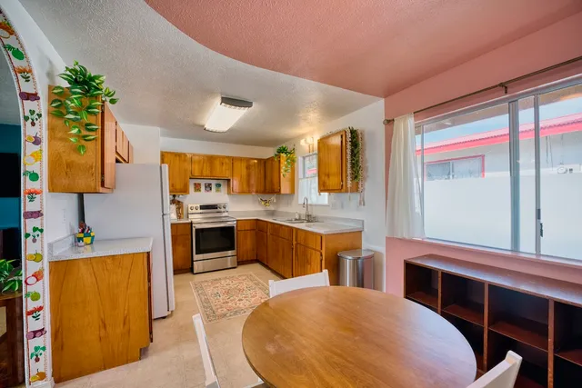 a kitchen with stainless steel appliances kitchen island granite countertop a sink and cabinets