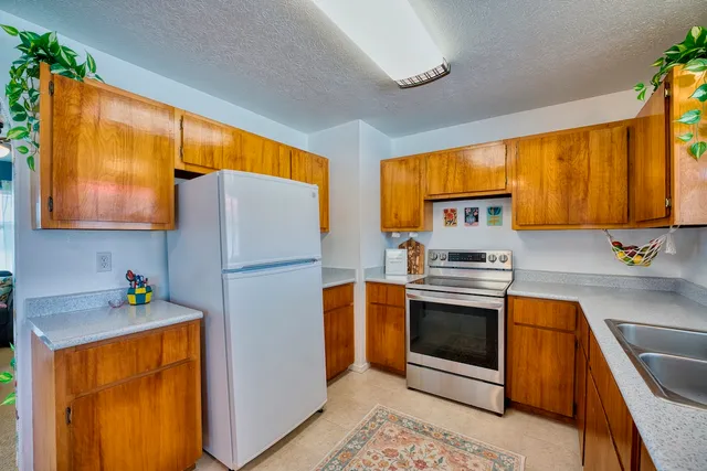 a kitchen with stainless steel appliances a stove a sink and a refrigerator