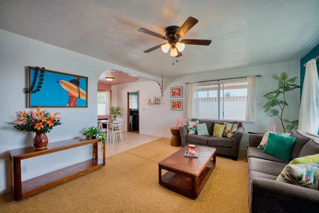 a living room with furniture and flowers