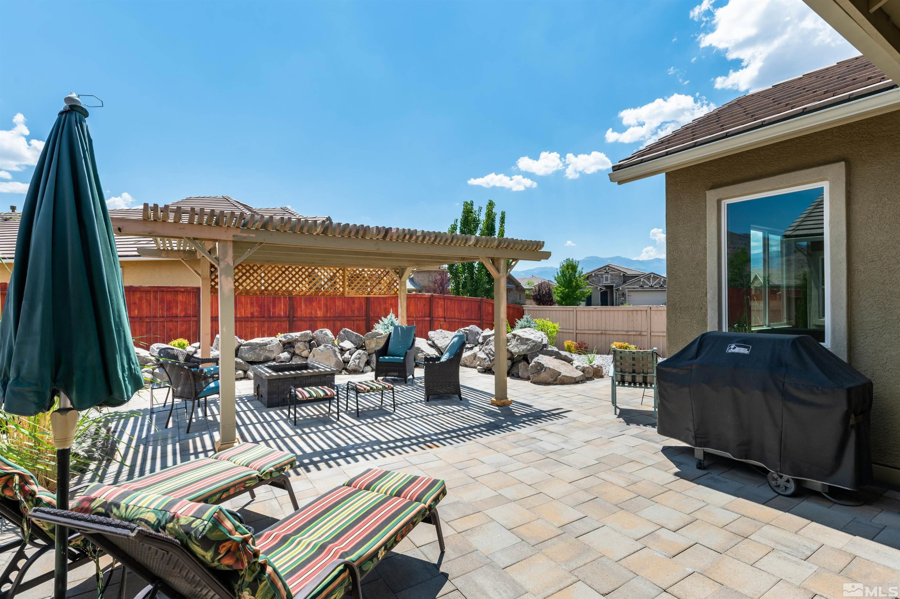 2084 Phaethon Lane Reno, NV 89521 - Photo 18 of 35 a view of a patio with couches table and chairs and potted plants