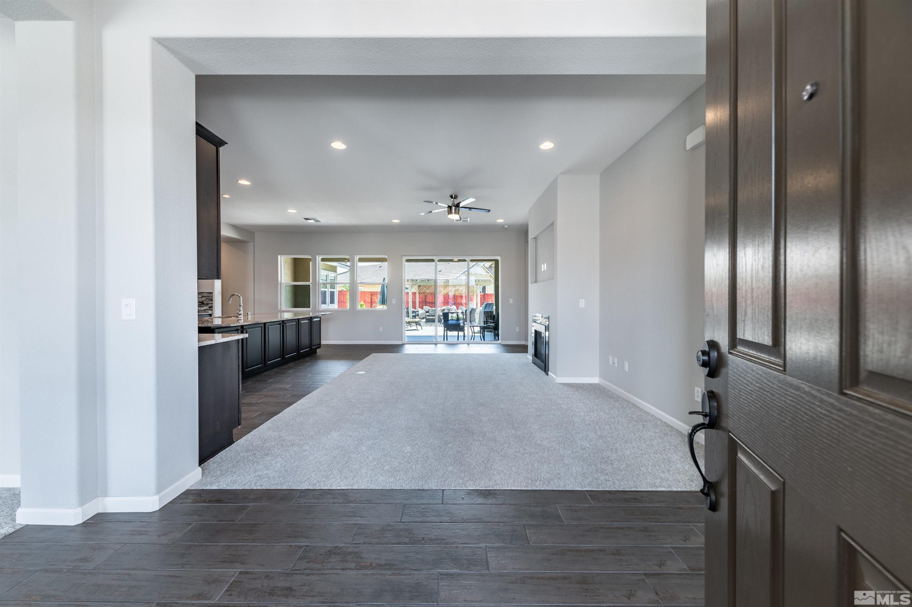 2084 Phaethon Lane Reno, NV 89521 - Photo 3 of 35 a view of a hallway with furniture and a refrigerator