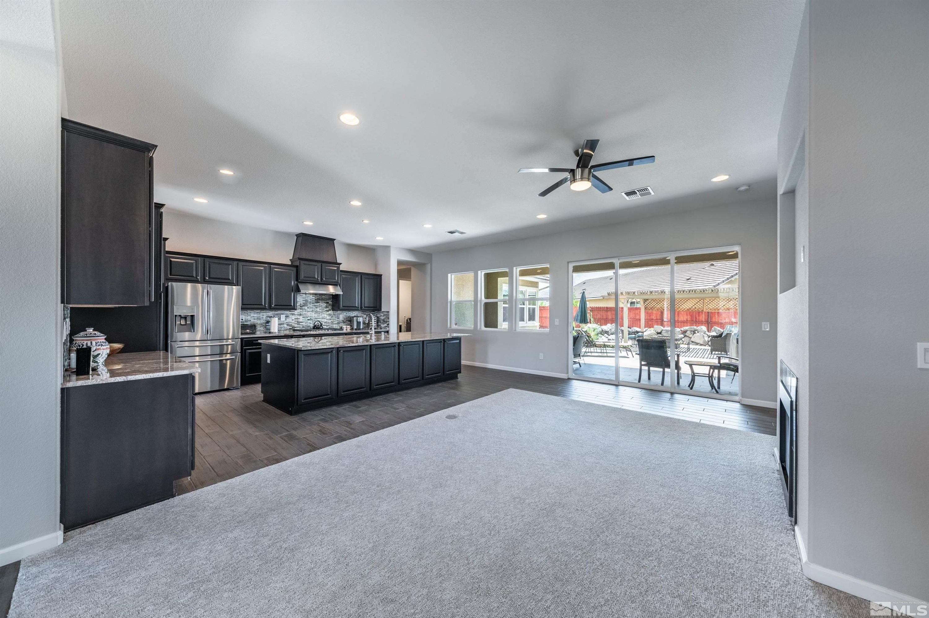 2084 Phaethon Lane Reno, NV 89521 - Photo 4 of 35 a living room with stainless steel appliances furniture a chandelier and a kitchen view