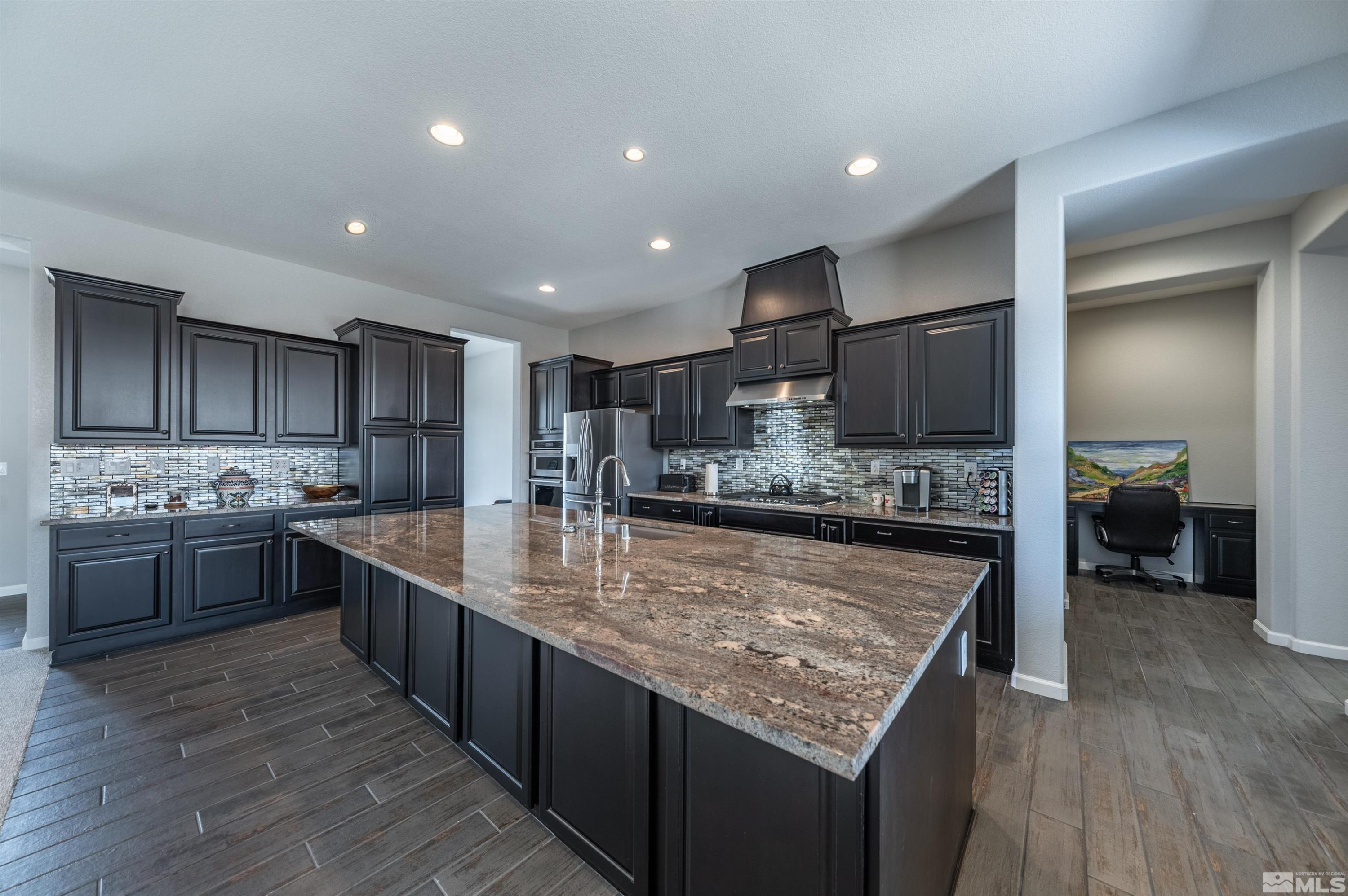 2084 Phaethon Lane Reno, NV 89521 - Photo 6 of 35 a large kitchen with stainless steel appliances lots of counter space and wooden floor