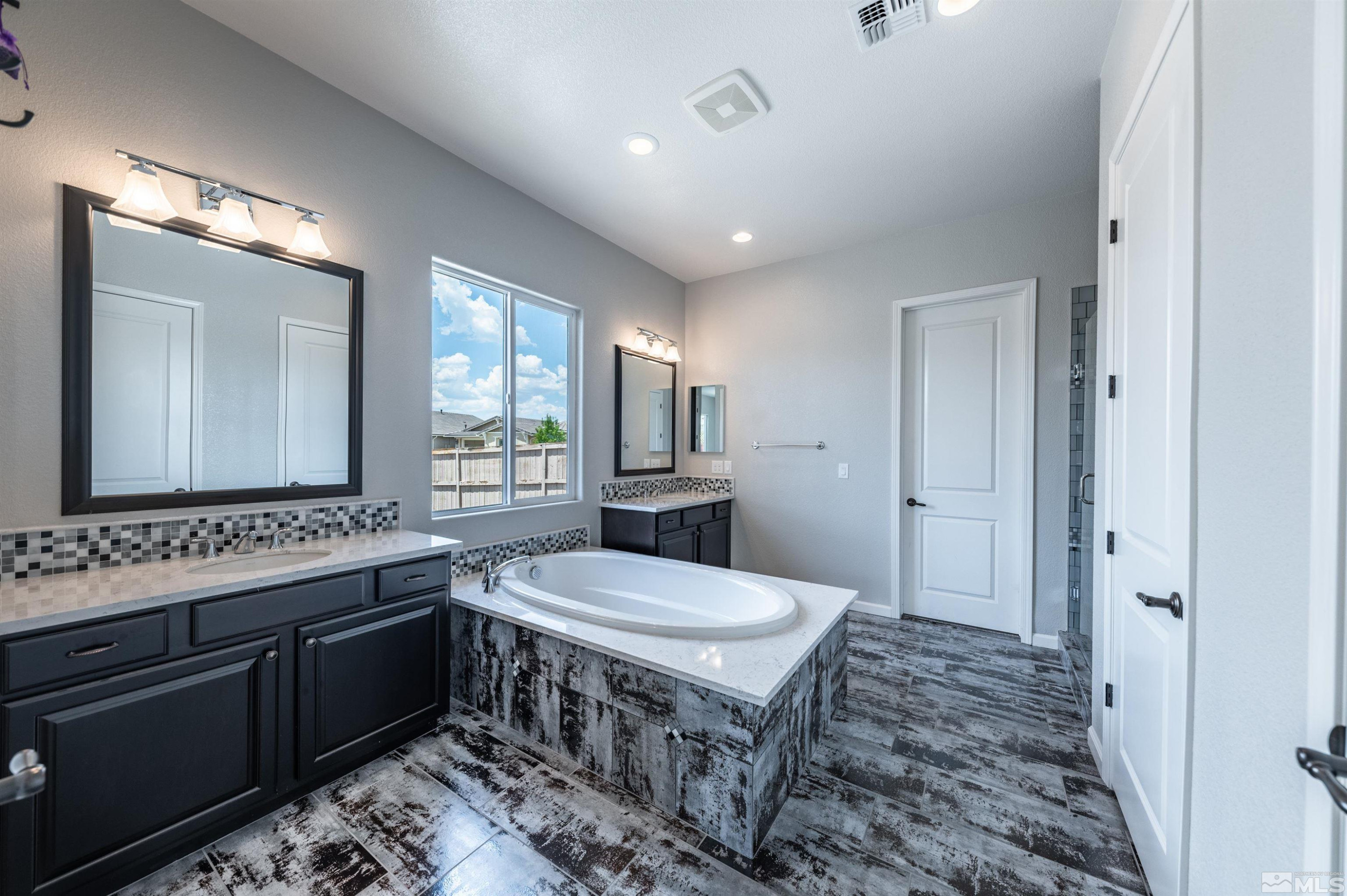 2084 Phaethon Lane Reno, NV 89521 - Photo 10 of 35 a bathroom with a sink a toilet a mirror and window