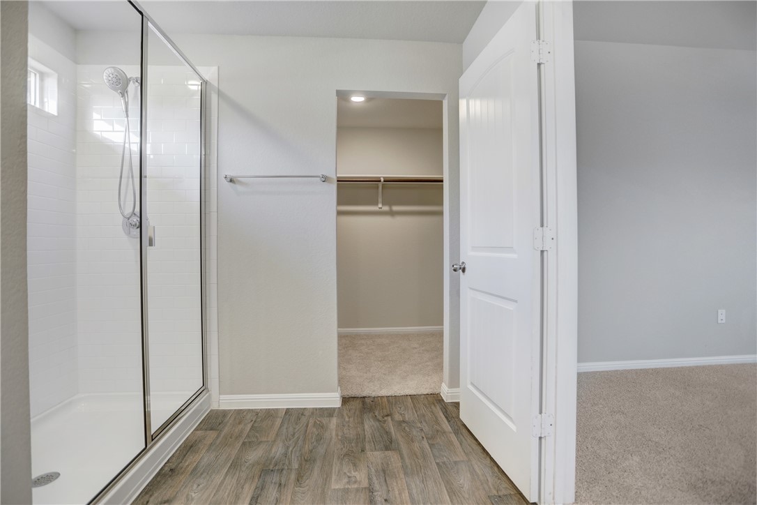 216 Strand Lane Bastrop, TX 78602 - Photo 6 of 13 a view of walk in closet with wooden floor